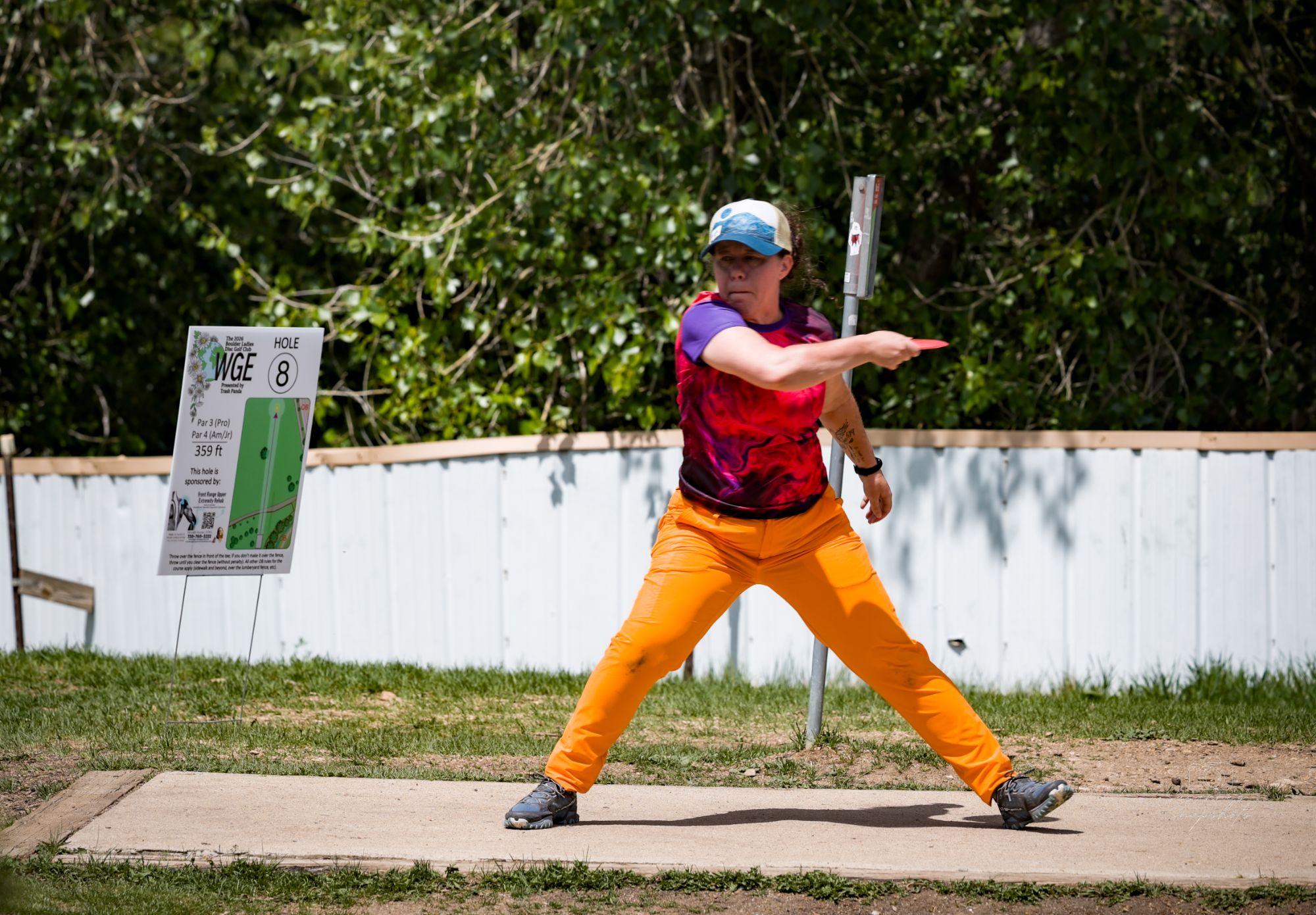 A player mid-throw on the tee pad